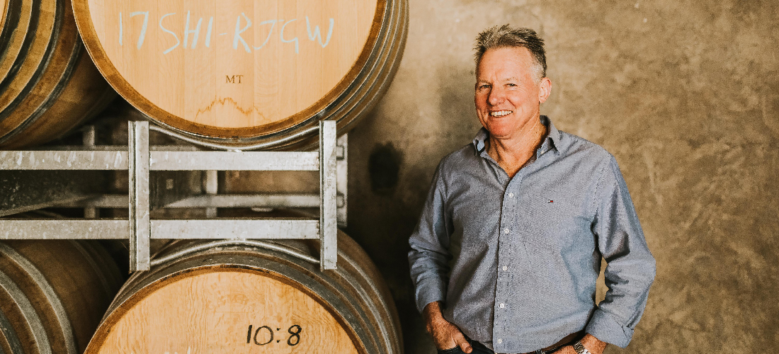 Winemaker by barrels